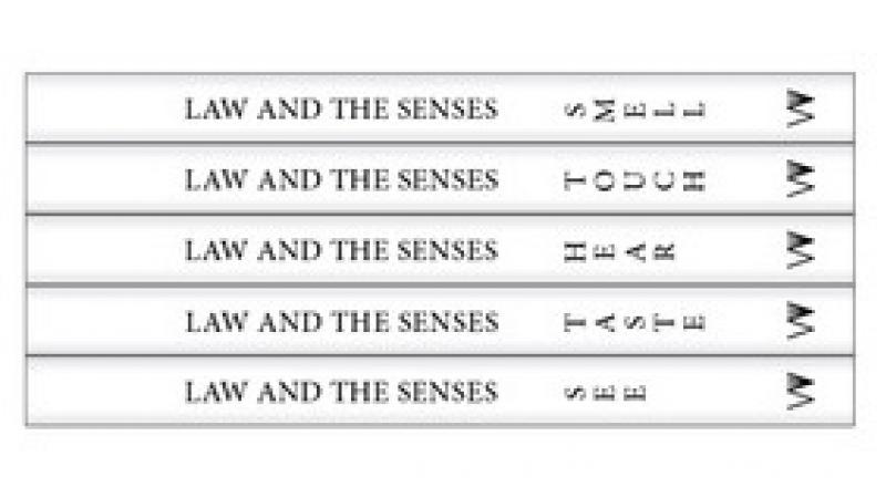 five white books stacked on top of each other with the five senses as titles