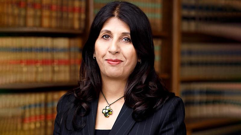 Lubna Shuja Westminster alumna portrait in the library of The Law Society