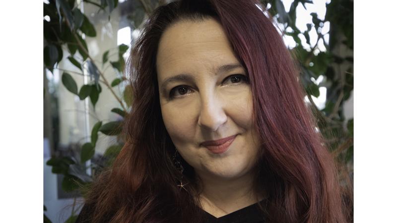 Headshot of Maria Barcenilla with leaves and trees in background