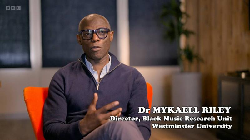 Screenshot of Mykaell Riley being interviewed for the BBC Two Documentary 'Lenny Henry's Caribbean Britain'.