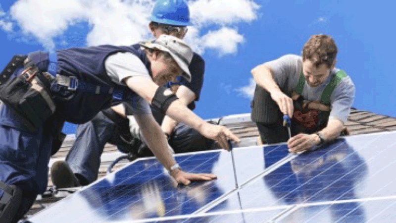 Workers fixing solar panels