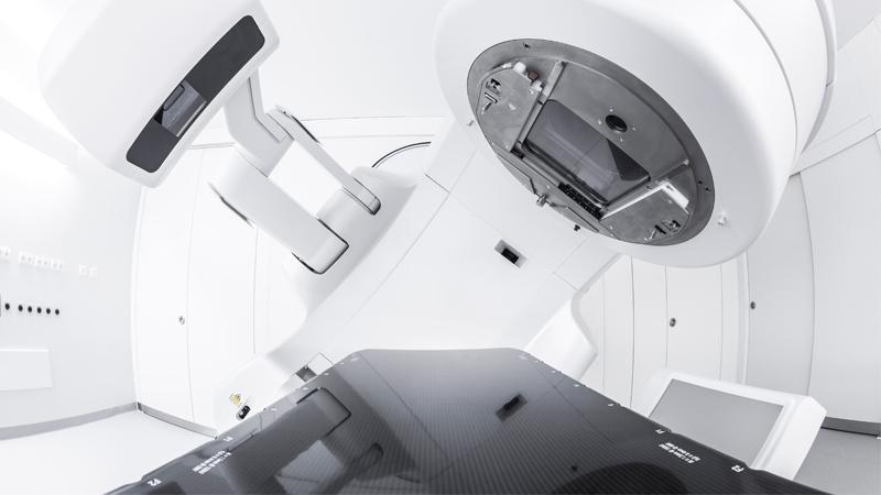 Image of a radiation therapy machine in white room