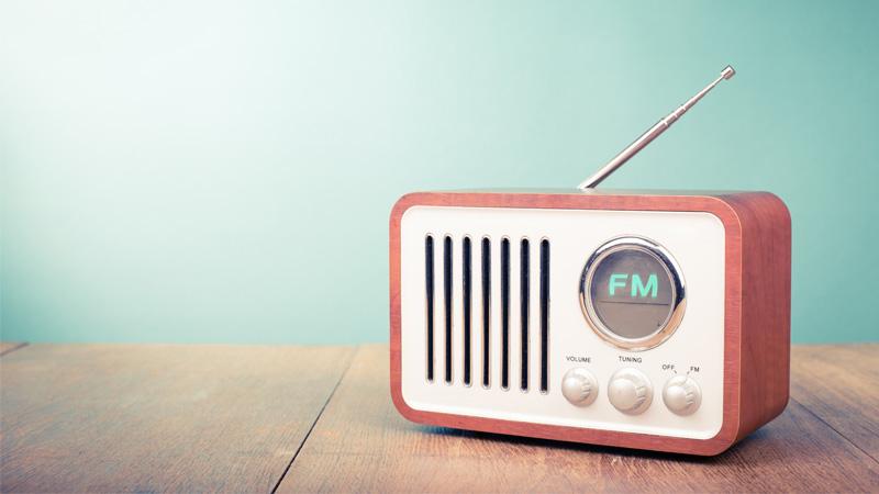 Retro old radio on mint green background.