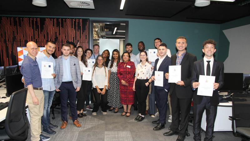 Picture of students and staff posing for a group photo at the School of Computer Science and Engineering Degree Show 2022.