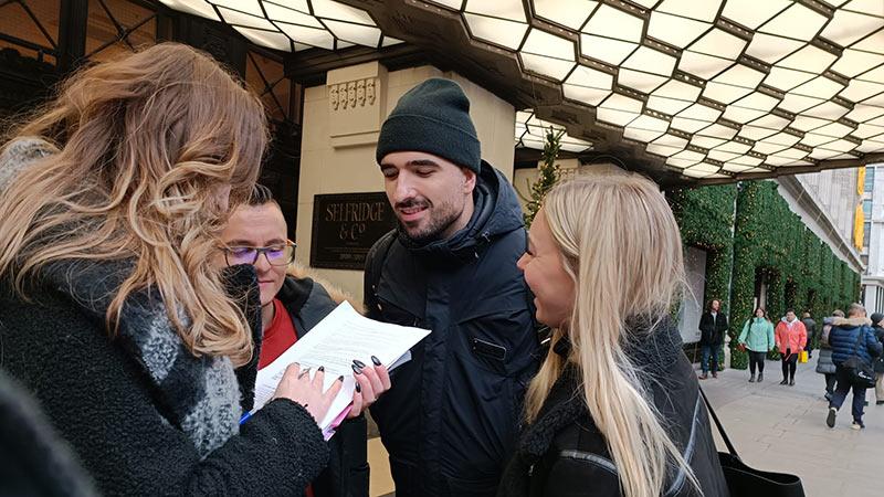 Students in a group with a notebook outside of Selfridges for gamified experience