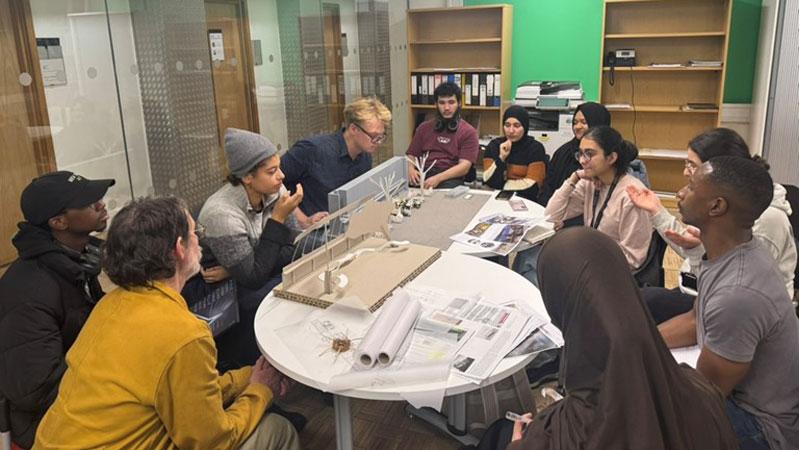 Students working together around a table on the Greening Westminster project.