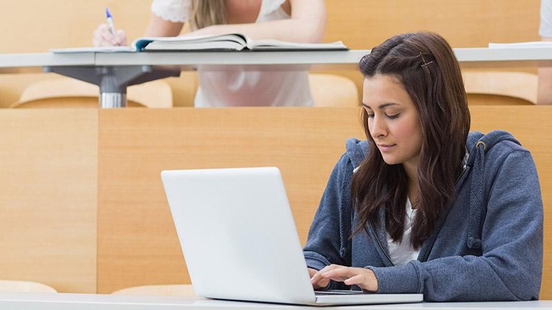 Students writing in a lecture theatre