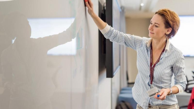 A teacher at a white board