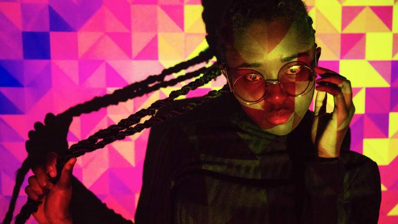 Girl looking at the camera with a colourful background