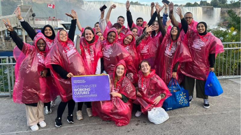 Group of Westminster students posing in front of a waterfall.
