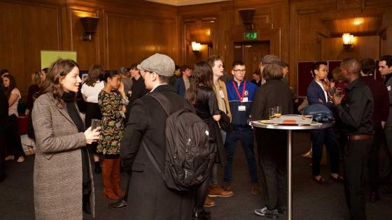 A room full of people talking at the event