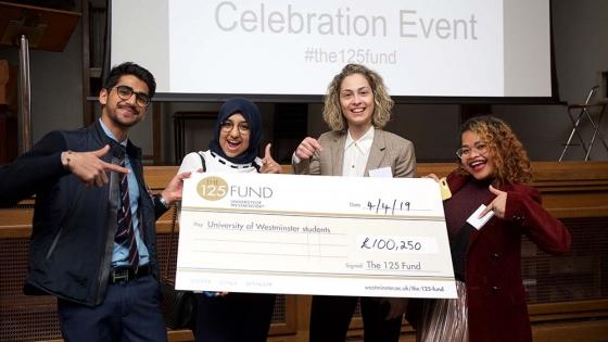 Students holding a cheque