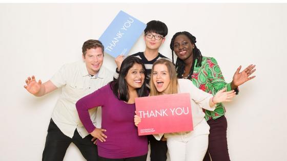 Students and staff with thank you signs