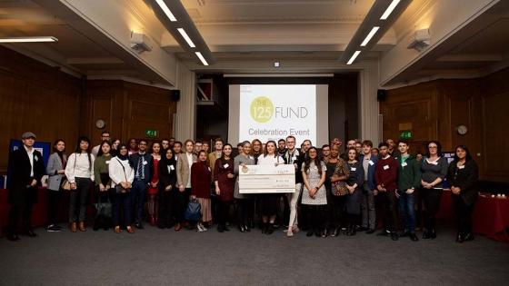 A group of students holding a cheque