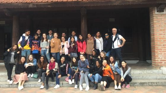 A group of students posing for a picture on a group trip