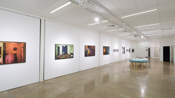 A large white room with artwork hanging on the walls