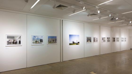 A large white wall with artwork hanging on it