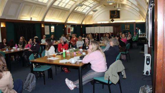 A room of women sitting at tables