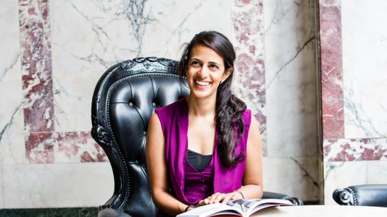 A student reading a book and smiling