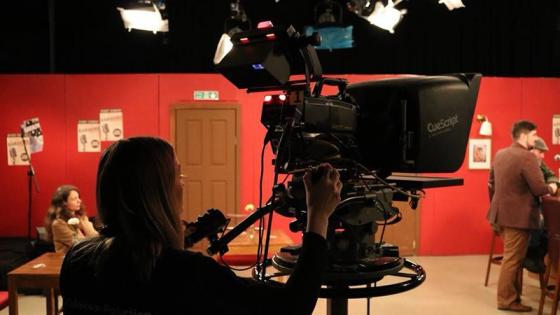 Third year camera operator checks focus between takes