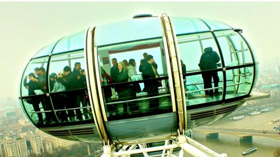 Photo of people in one of the cars of an observation wheel