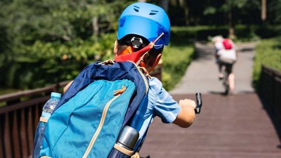 A boy riding a bicycle in a park