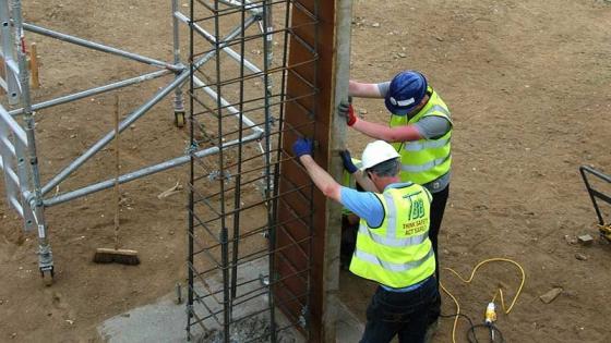 Two workers on a construction site