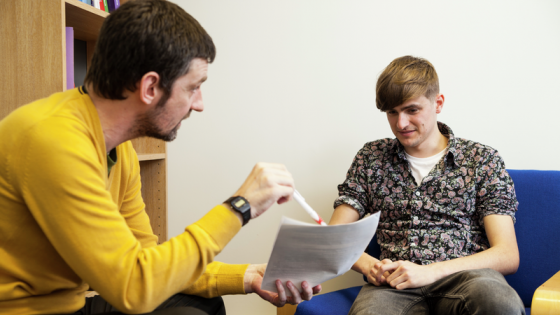 University of Westminster, Harrow Campus. A male, sitting on the left, talking to a male student sitting on the right