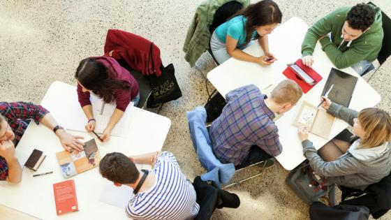 A group of students working at tables
