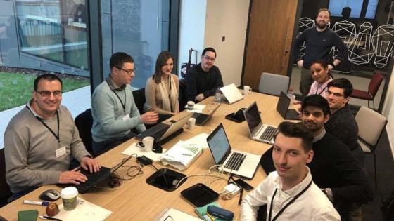 Phd students sitting together at a table during the event