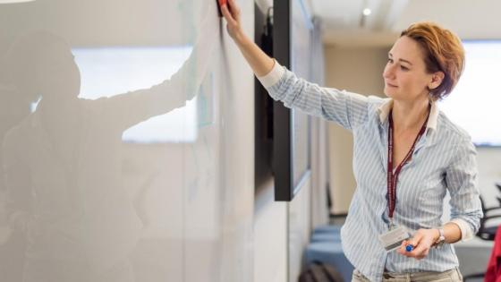 A teacher at a white board